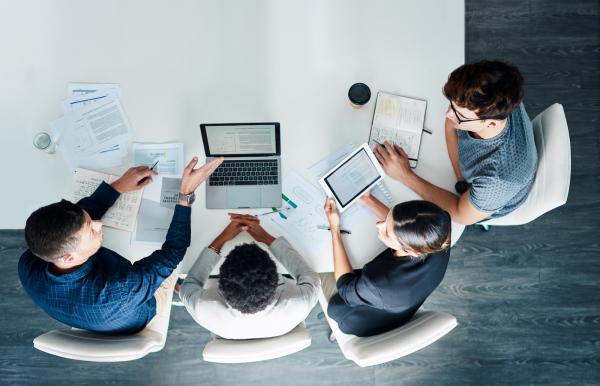 People sitting around a laptop